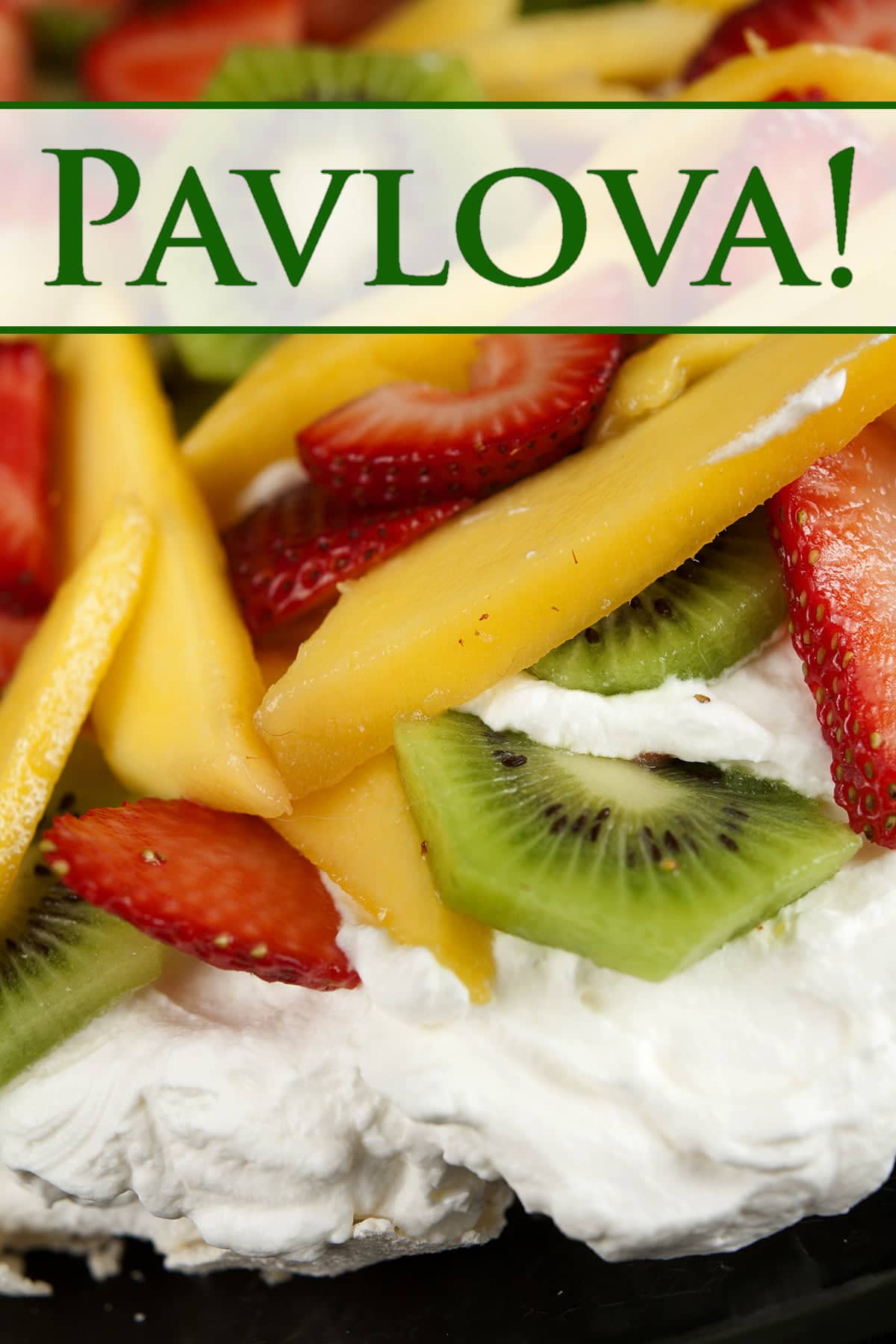 Close up view of a Pavlova: White meringue topped with whipped cream, strawberries, kiwi fruit, and mango slices.
