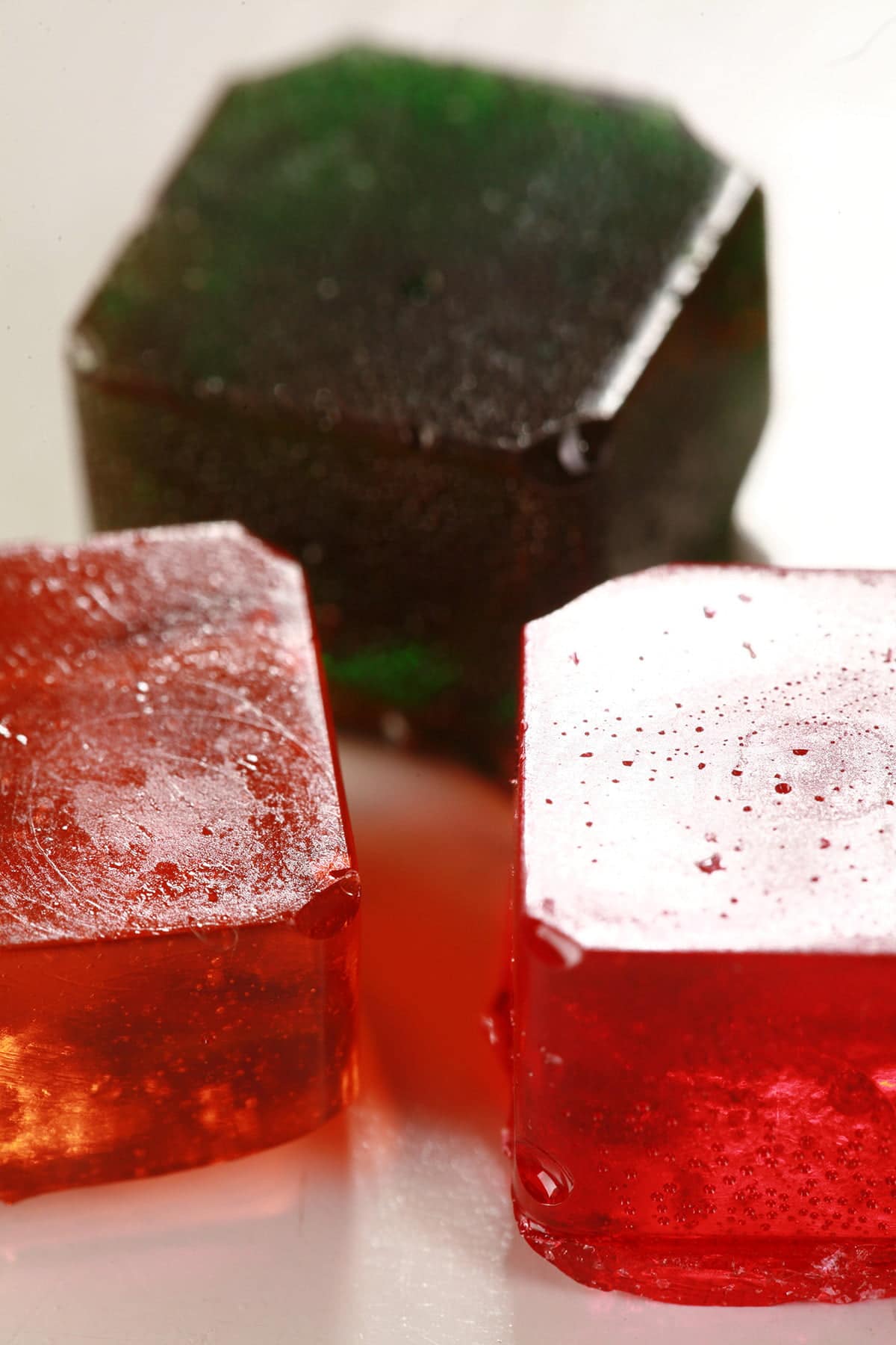 3 squares of colourful hard candy are shown on a white background.