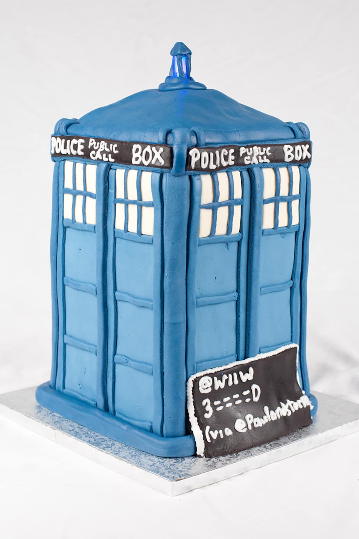 The TARDIS cake, with the top light lit.