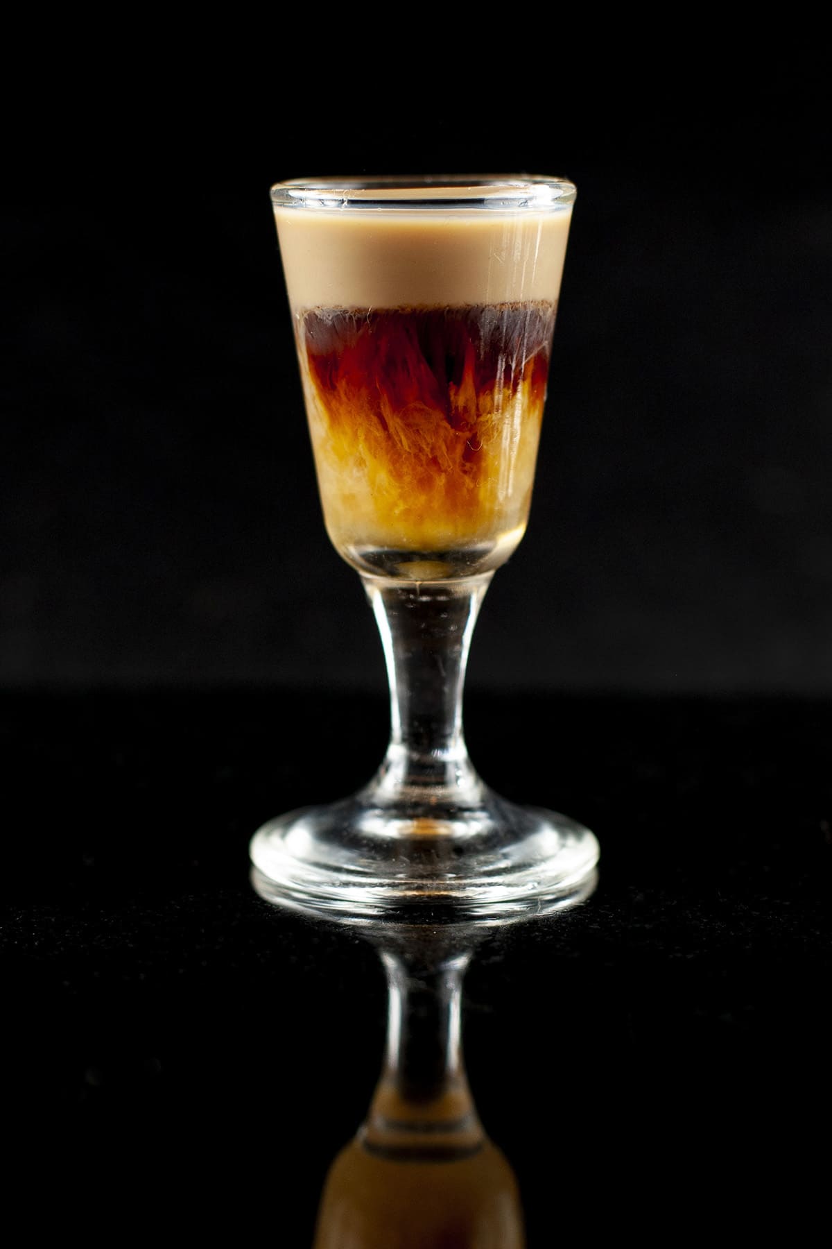 A brown and cream coloured layered shot. The bottom layer is streaking up into the middle layer.