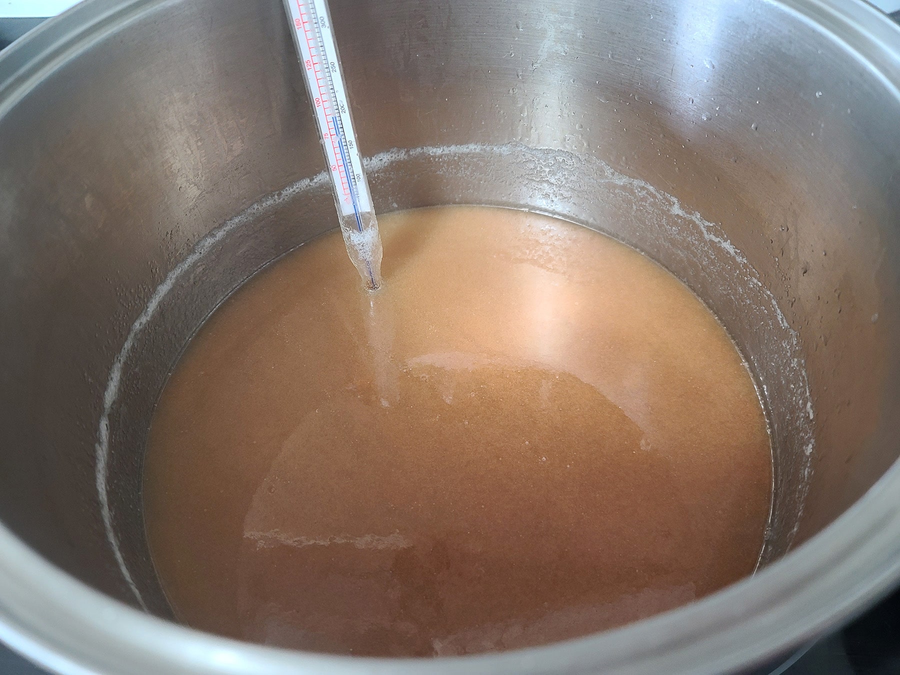 The pot of fudge has been taken off the burner and is cooling.