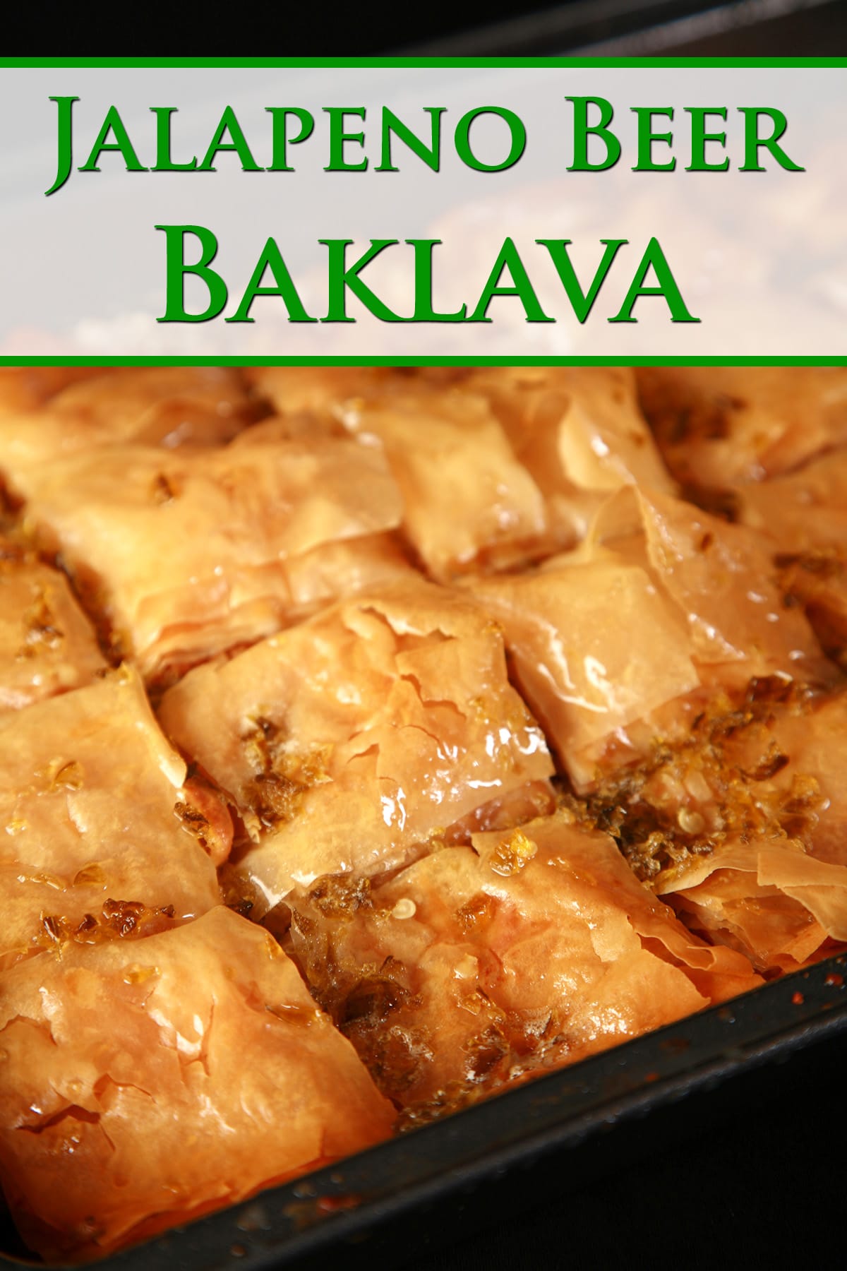 A close up view of a pan of jalapeno beer baklava, cut into squares.