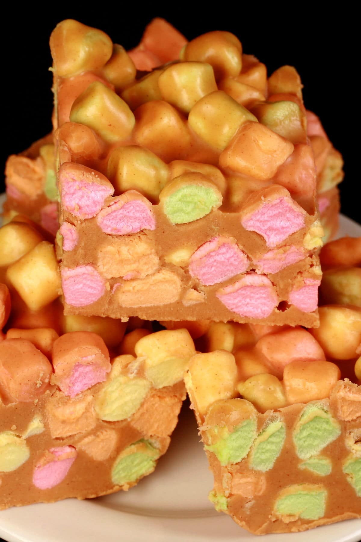 Close up view of butterscotch fudge squares, loaded with rainbow marshmallows.