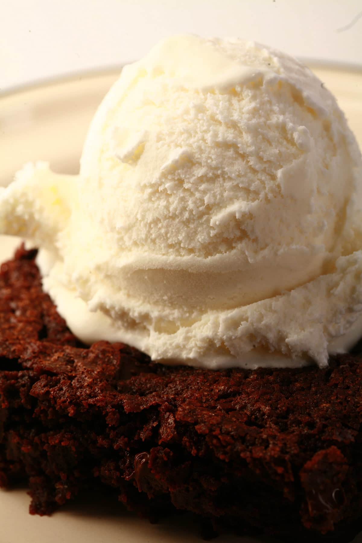 A large double chocolate brownie, topped with vanilla ice cream.