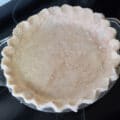 An unbaked perfect pie crust, with the edges crimped.