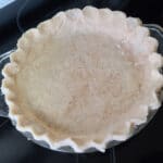 An unbaked perfect pie crust, with the edges crimped.