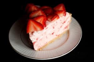 A slice of strawberry Grand Marnier Chiffon Pie on a small white plate.