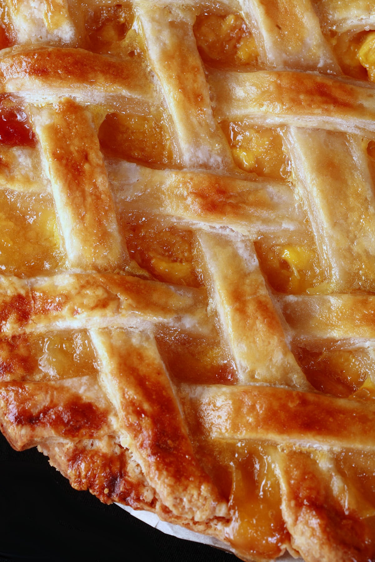 A close view of a lattice topped pie made with this flaky perfect pie crust.