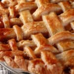 A close view of a lattice topped pie made with this flaky perfect pie crust.