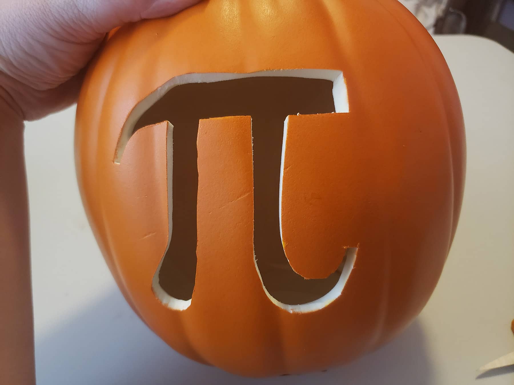 The pi symbol is cut out of a foam pumpkin.
