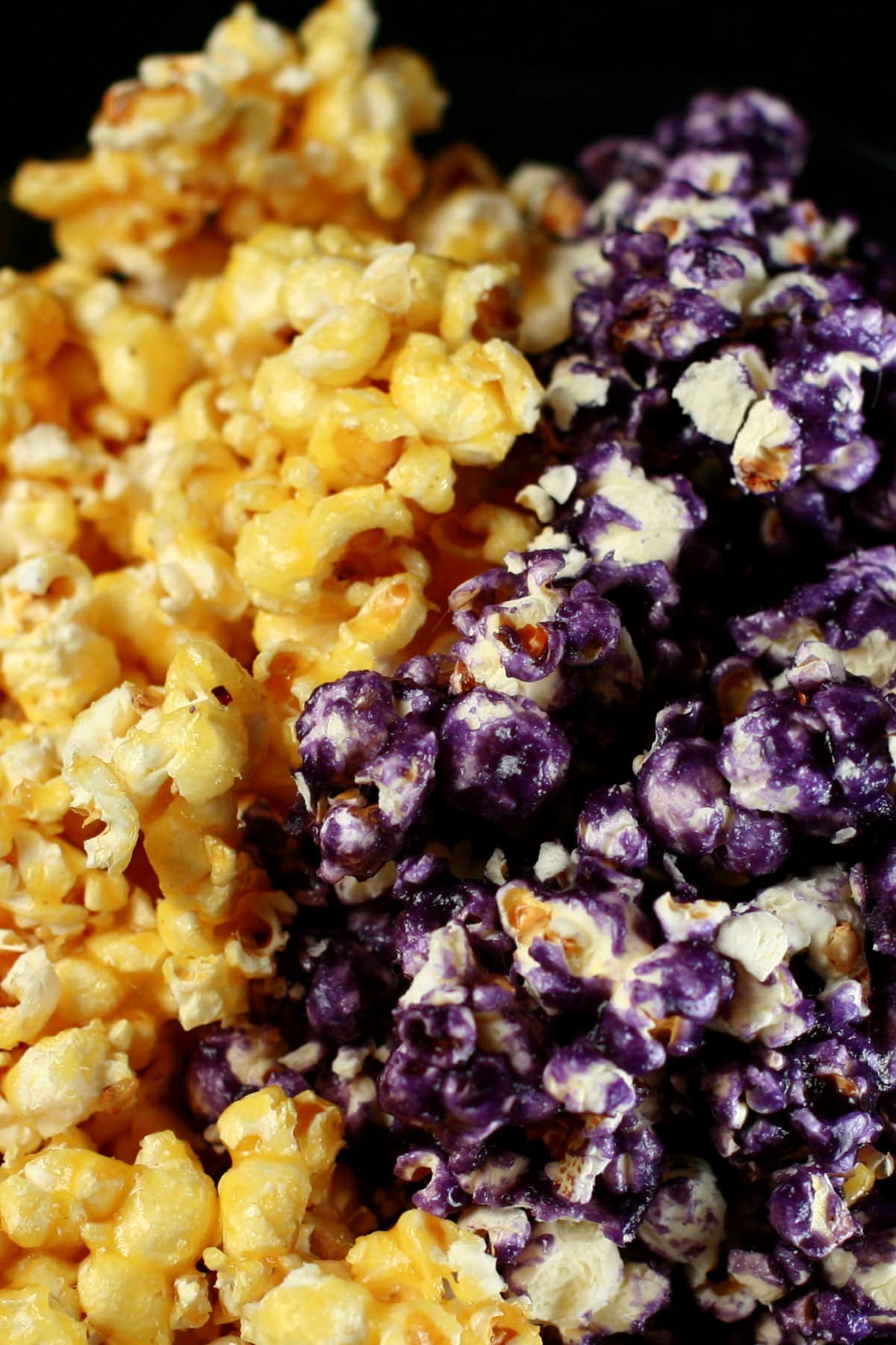 A close up view of yellow and purple glazed popcorn.