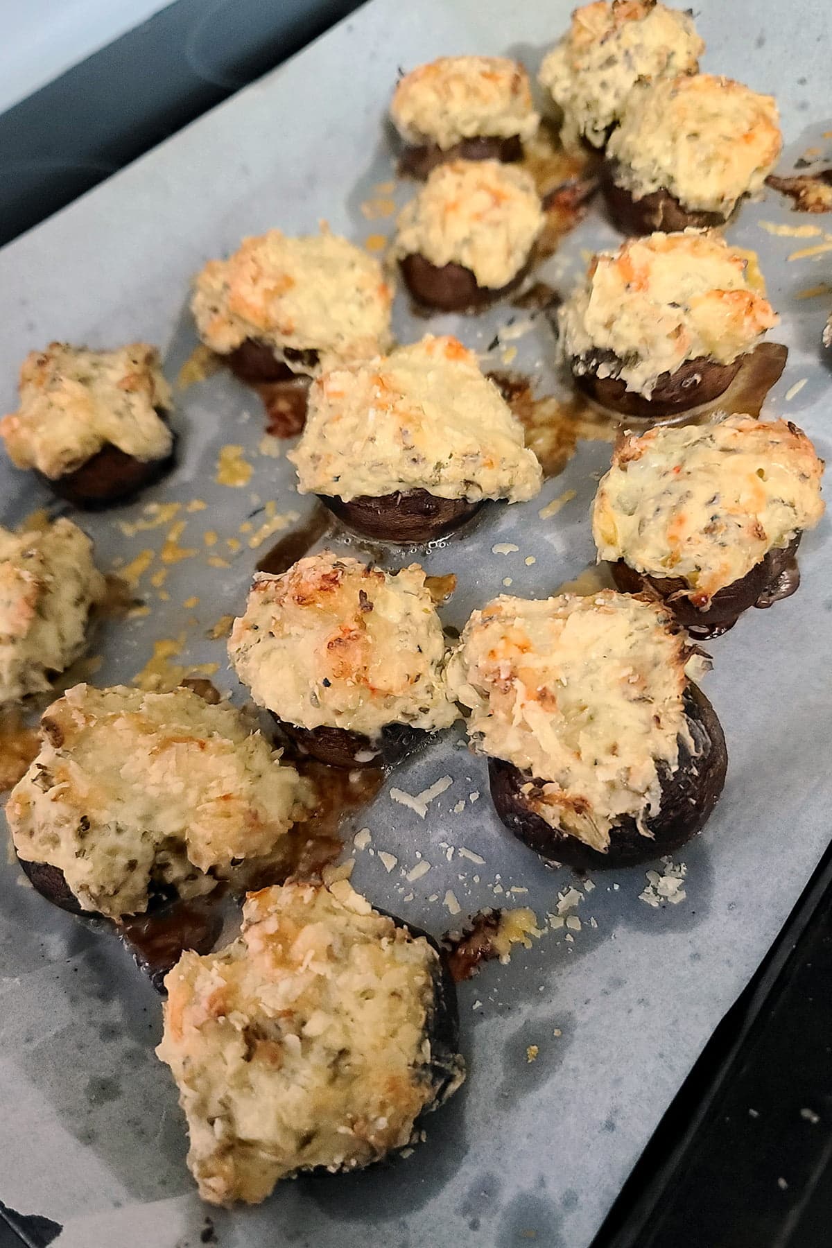 The stuffed mushrooms on the pan, fresh out of the oven.