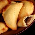 A plate piled with golden brown mushroom turnovers.