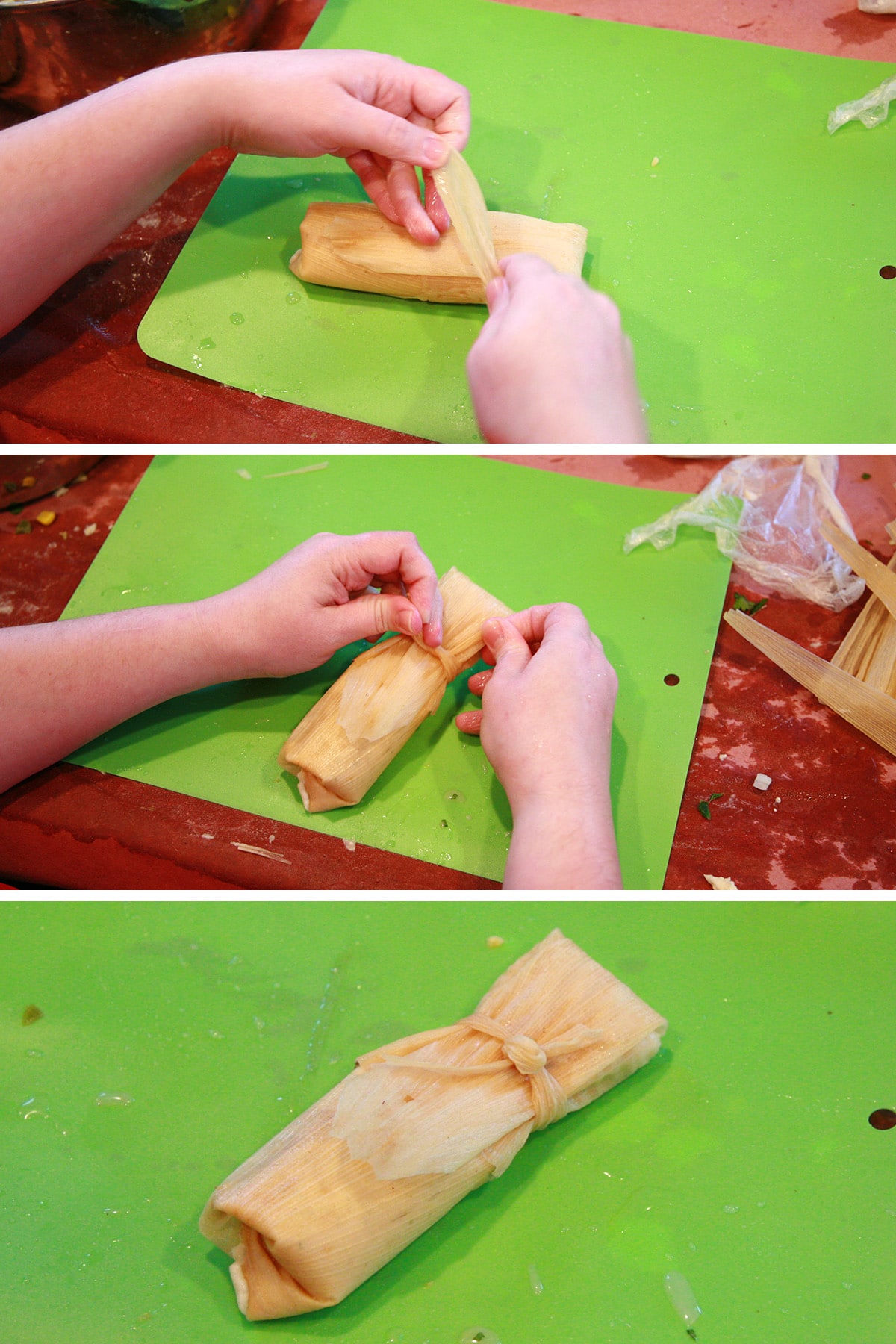 Two hands fold and tie off the tamale, as described.