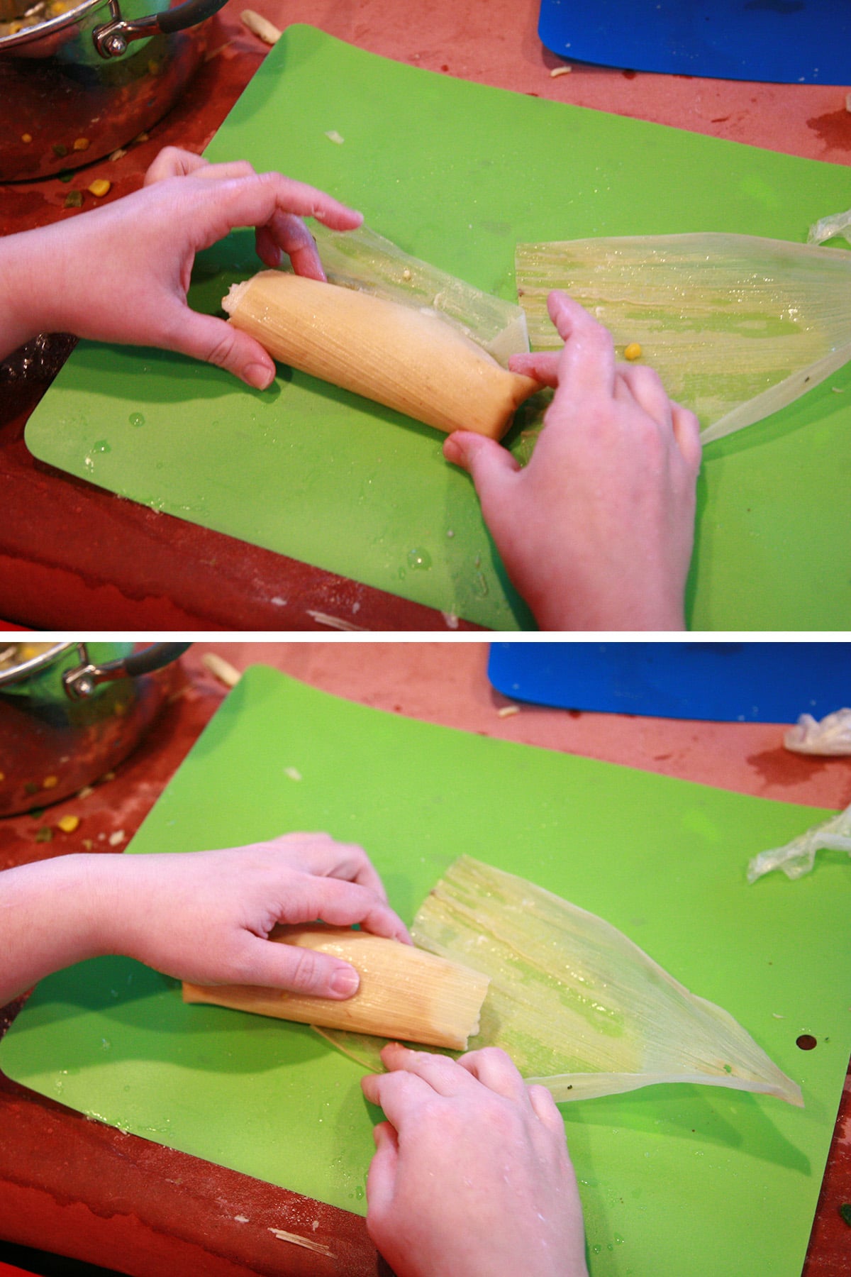 Two hands roll the tamale, as described.