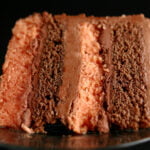 A large slice of B-52 Torte - Layers of mocha and orange cakes, separated by layers of blood orange ganache and Irish Cream buttercream.