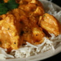 A plate with rice smothered in a creamy Chicken Korma.
