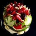 A Canada Day, Canadian Themed Watermelon Bowl. White and red maple leaves are carved into the watermelon, which is filled with red and white fruit.