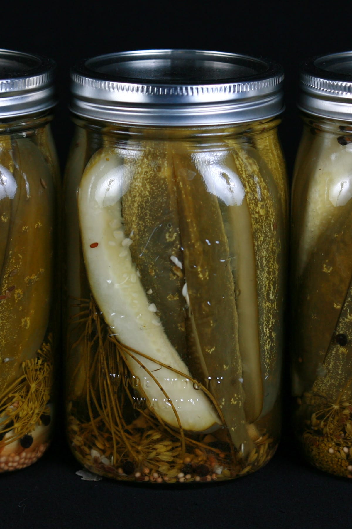 3 large jars of homemade dill pickles.