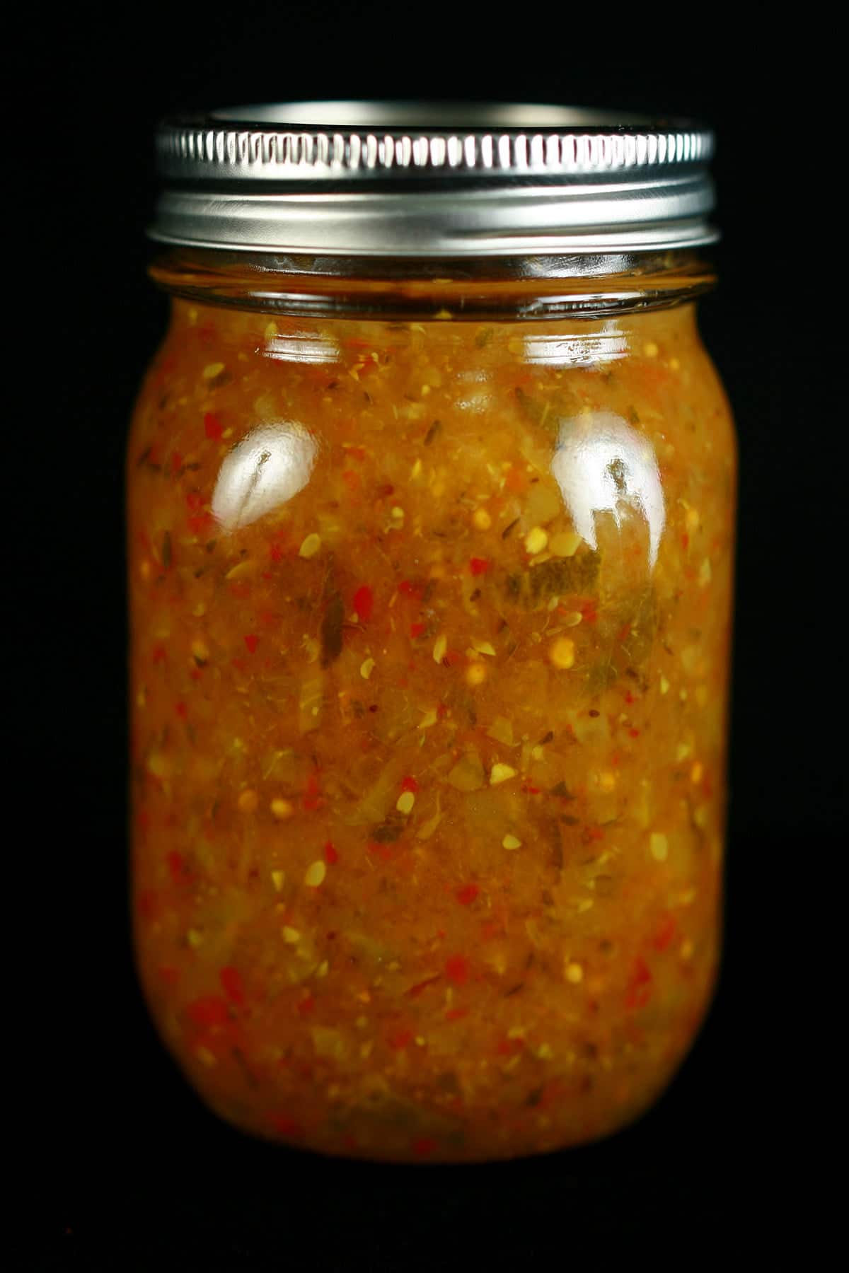 3 jars of Hoppy Dill Pickle Relish. It's a golden orange relish with flecks of dark green and red throughout.