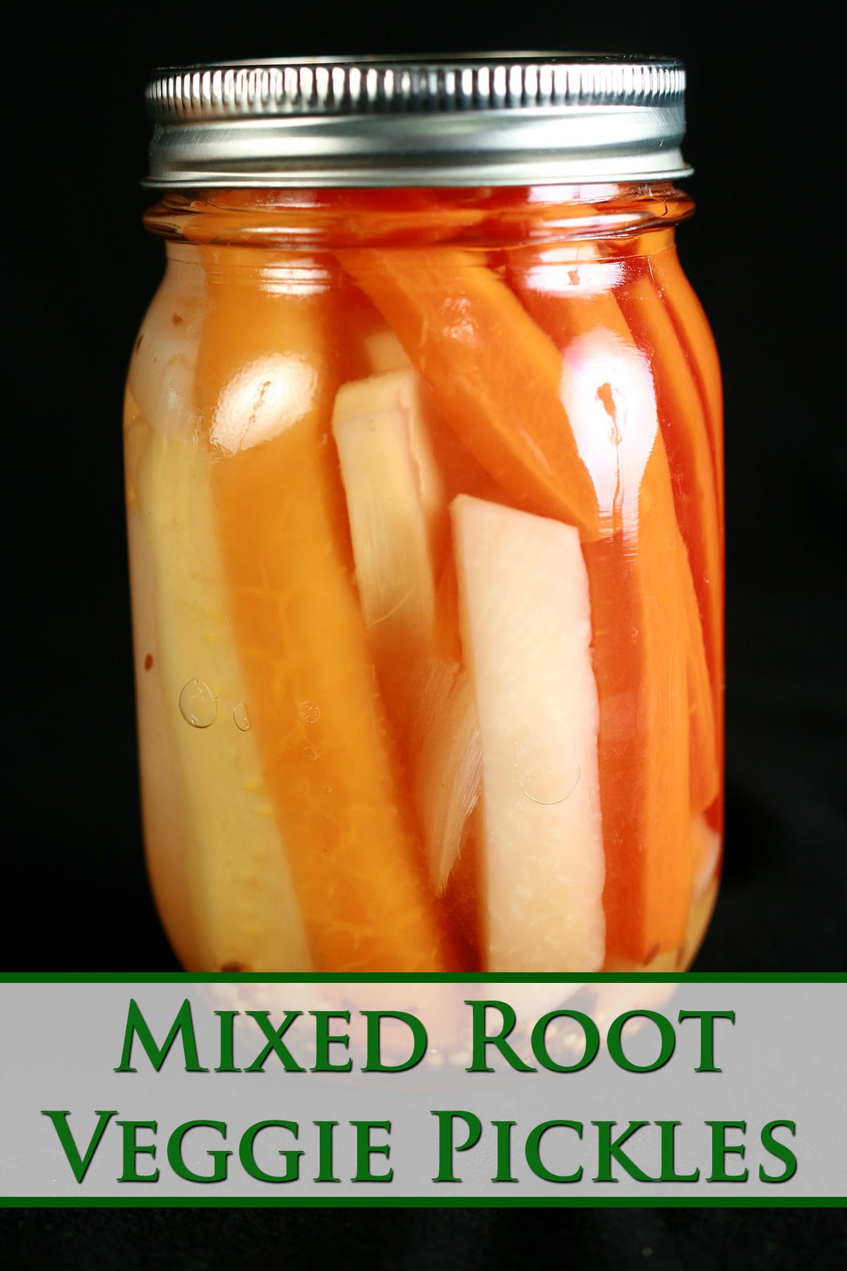 A jar of mixed root vegetable pickles. Spears of carrot, parsnip, and turnip are visible.
