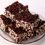 A stack of puffed wheat bars on a small white plate.