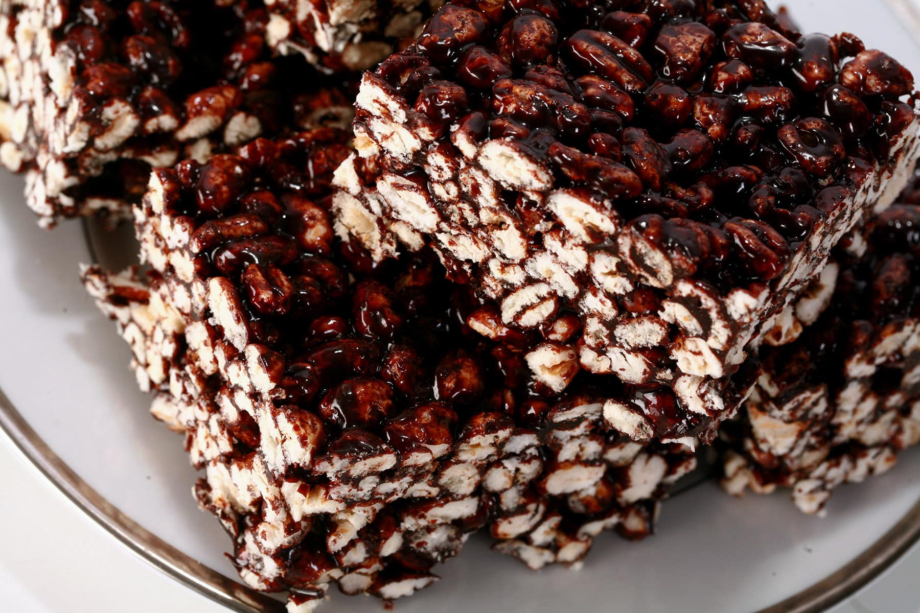 A stack of puffed wheat squares on a small white plate.