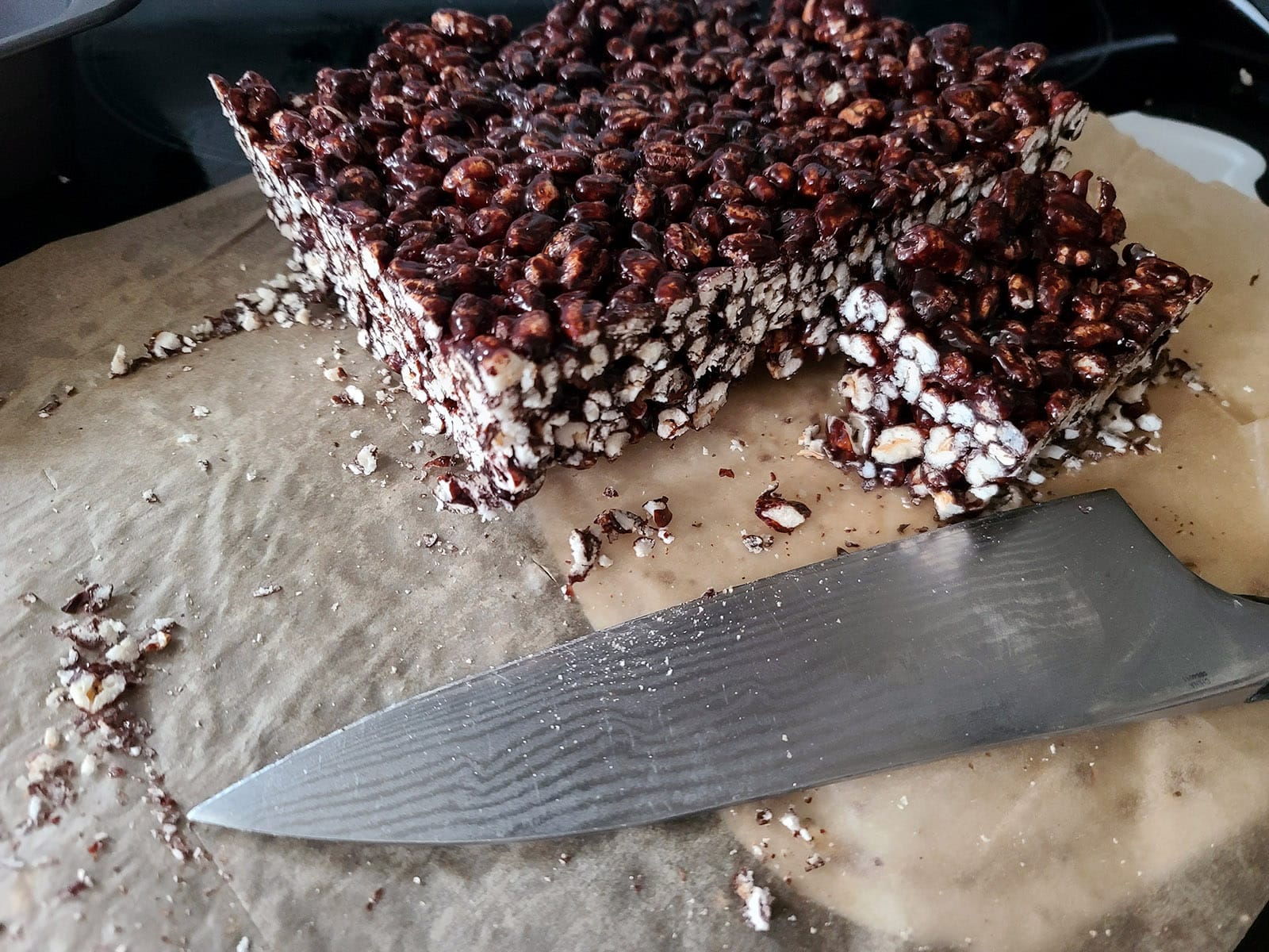 A slab of puffed wheat squares being cut.