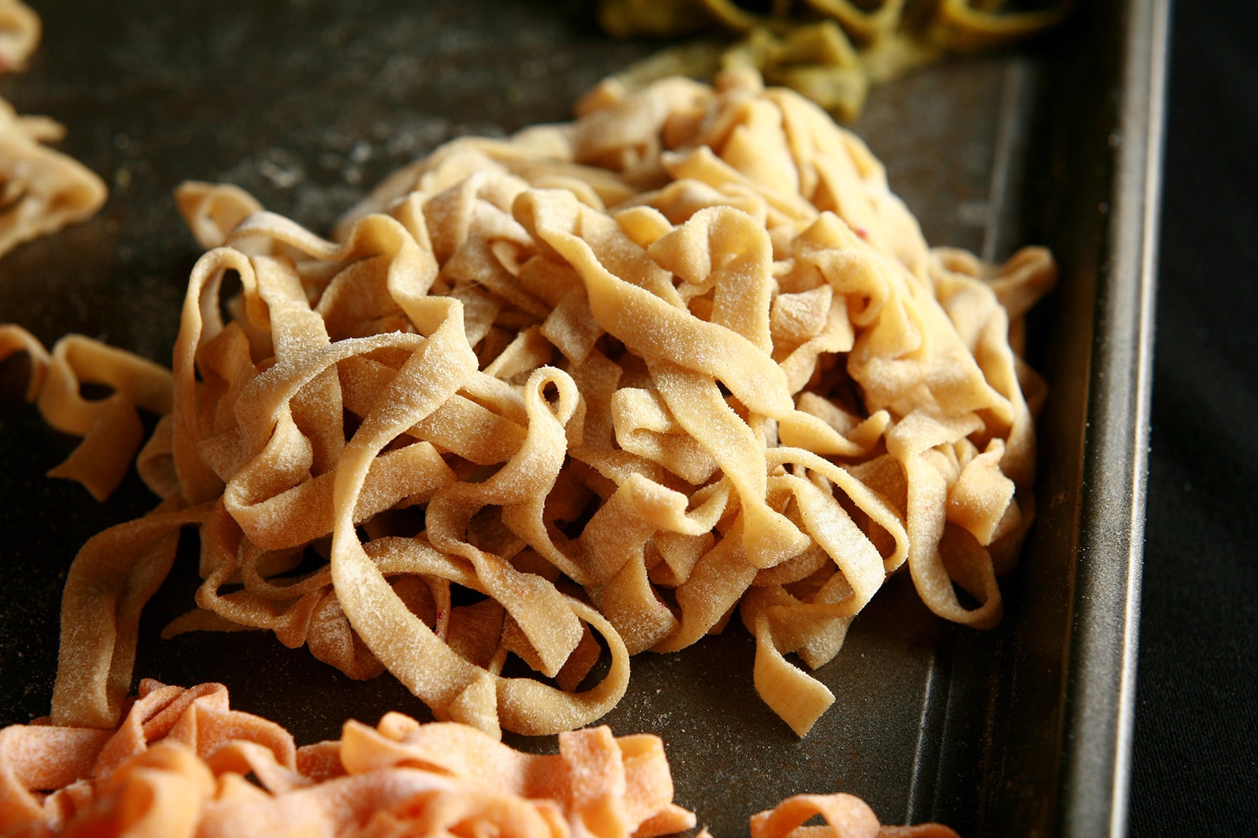 A close up view of a mound of fresh homemade linguini.