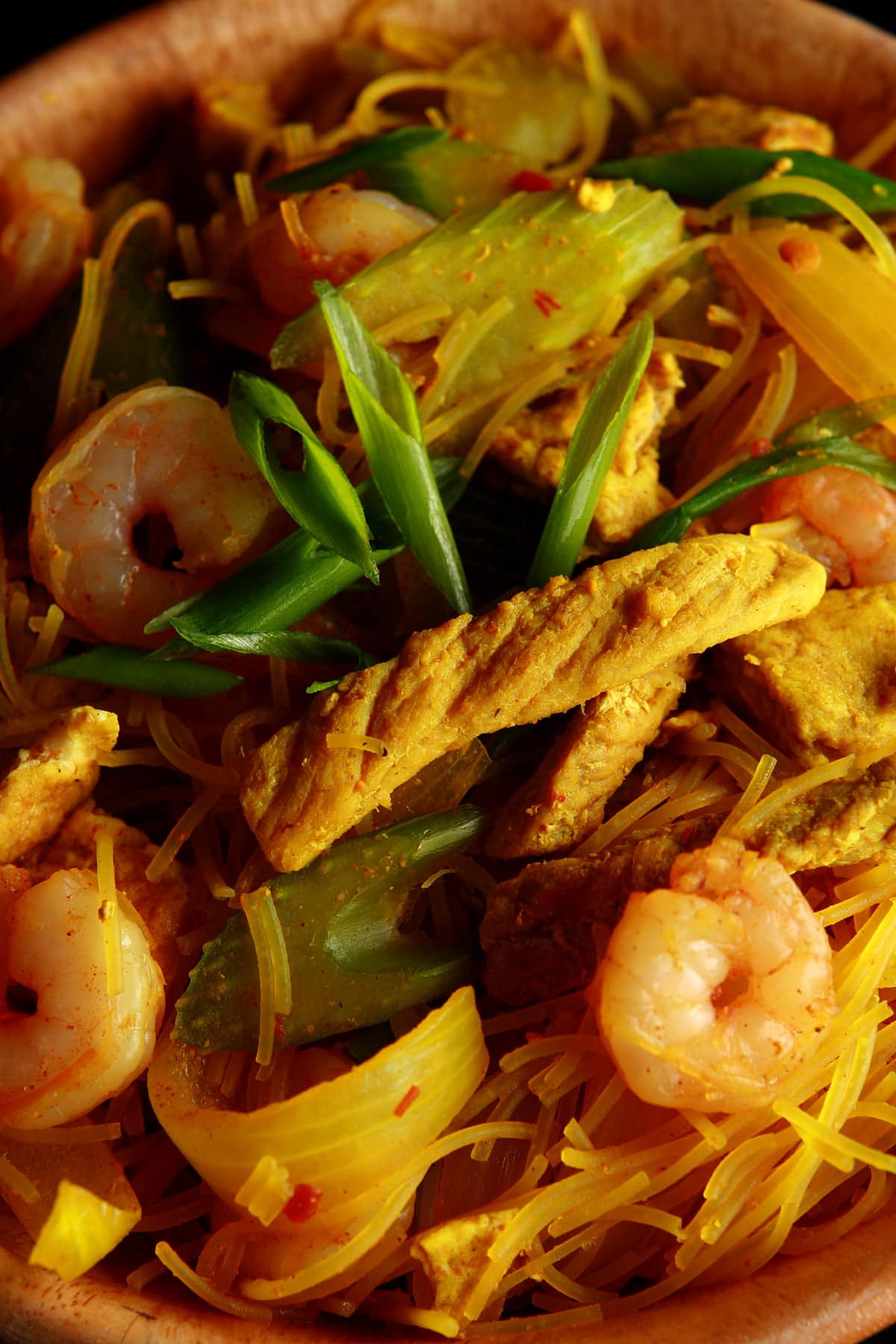 A large bowl of Singapore Mai Fun - curried vermacelli noodles with onion, celery, chicken, and shrimp visible throughout.