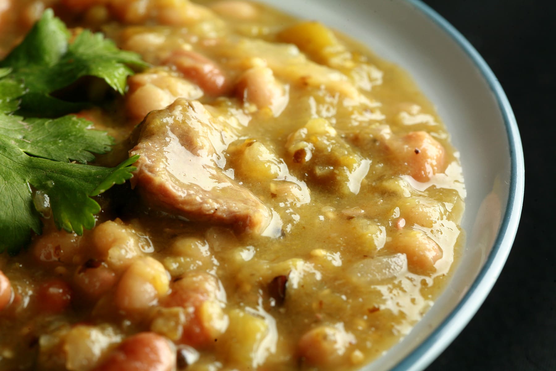 A close  up view of a bowl of roasted green chili.