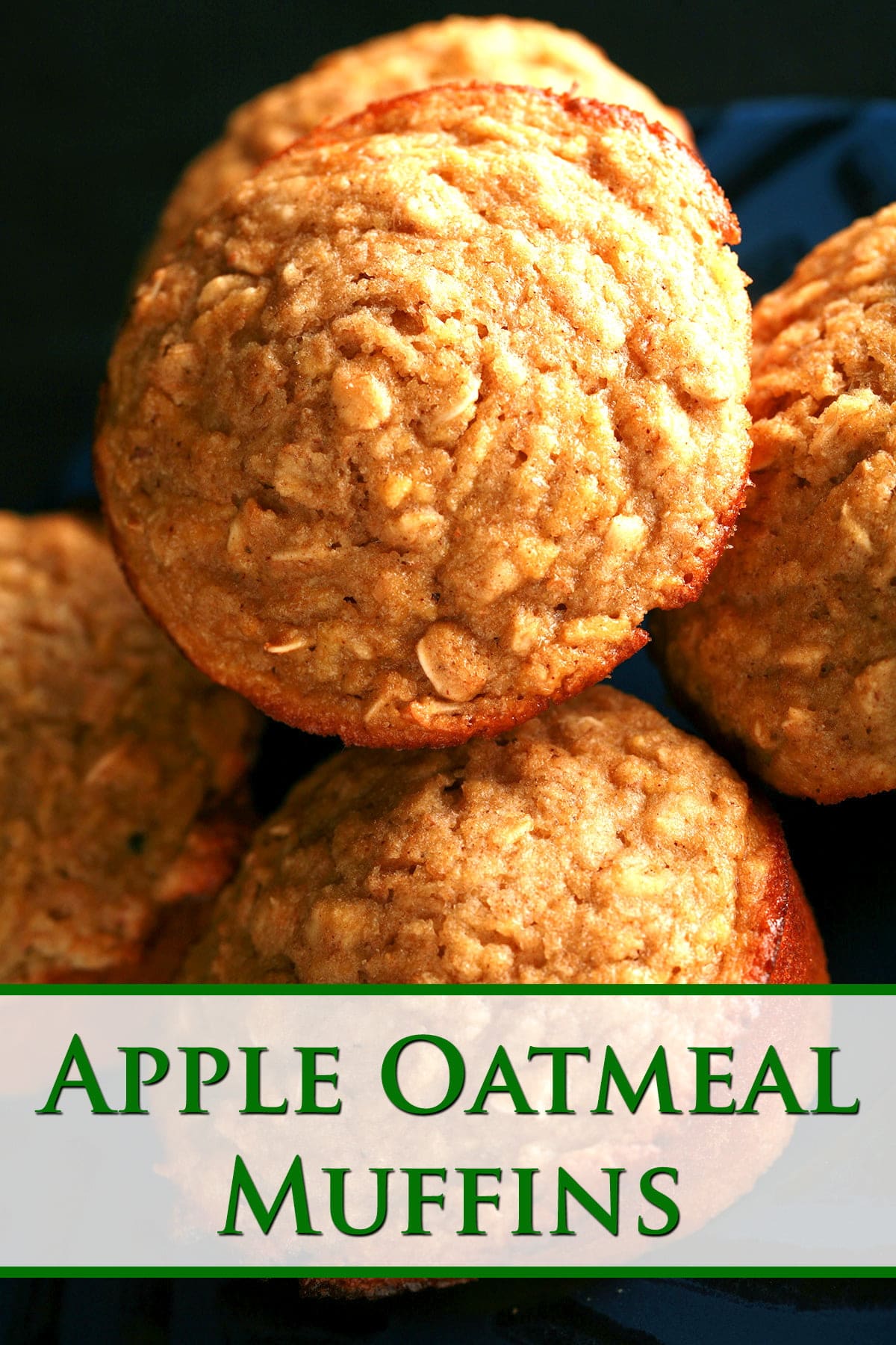 A small blue plate with a black geometric design around the edge is stacked with these healthier apple oatmeal muffins.