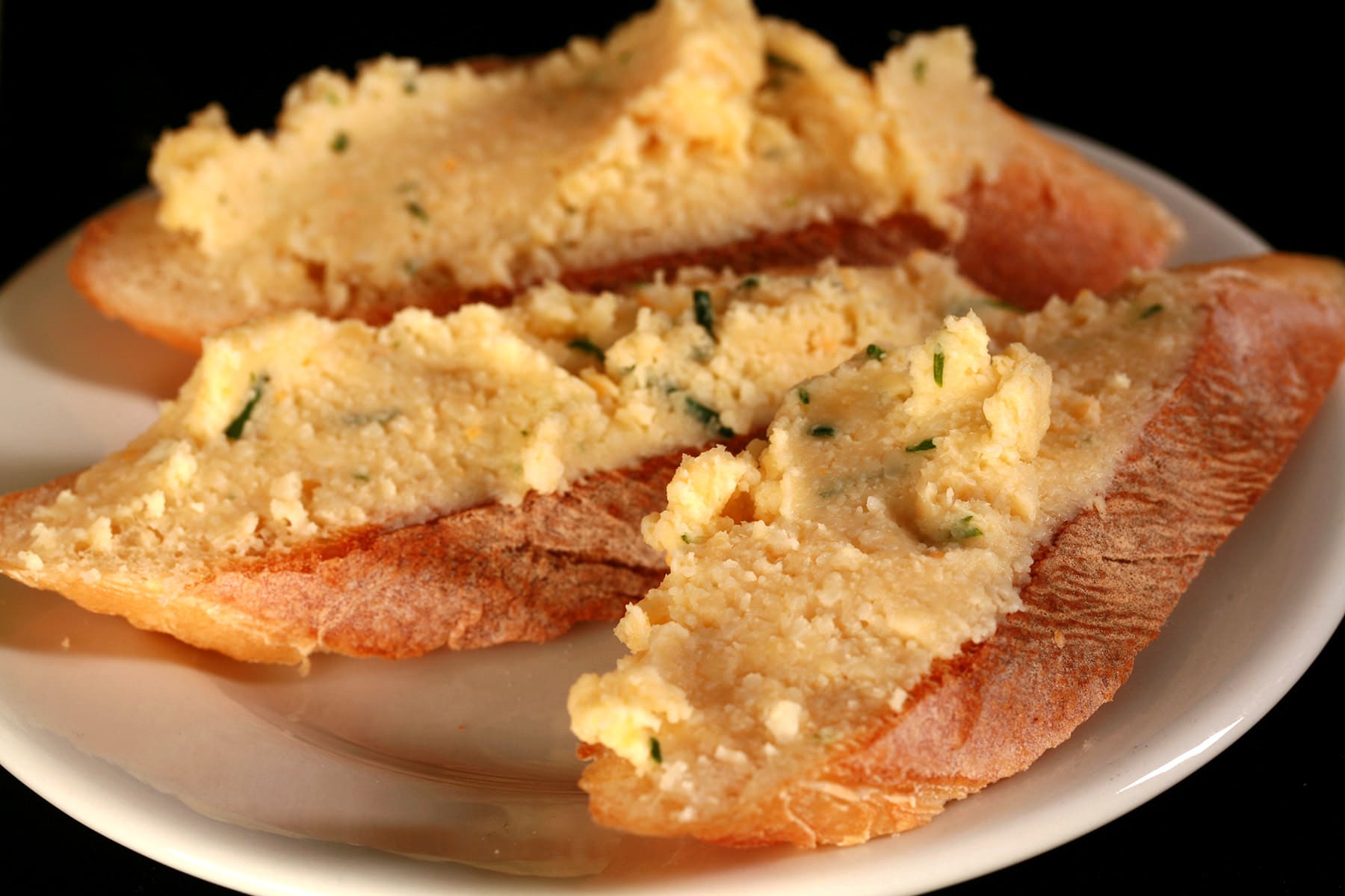 Cold fromage fort spread on thin slices of baguette.