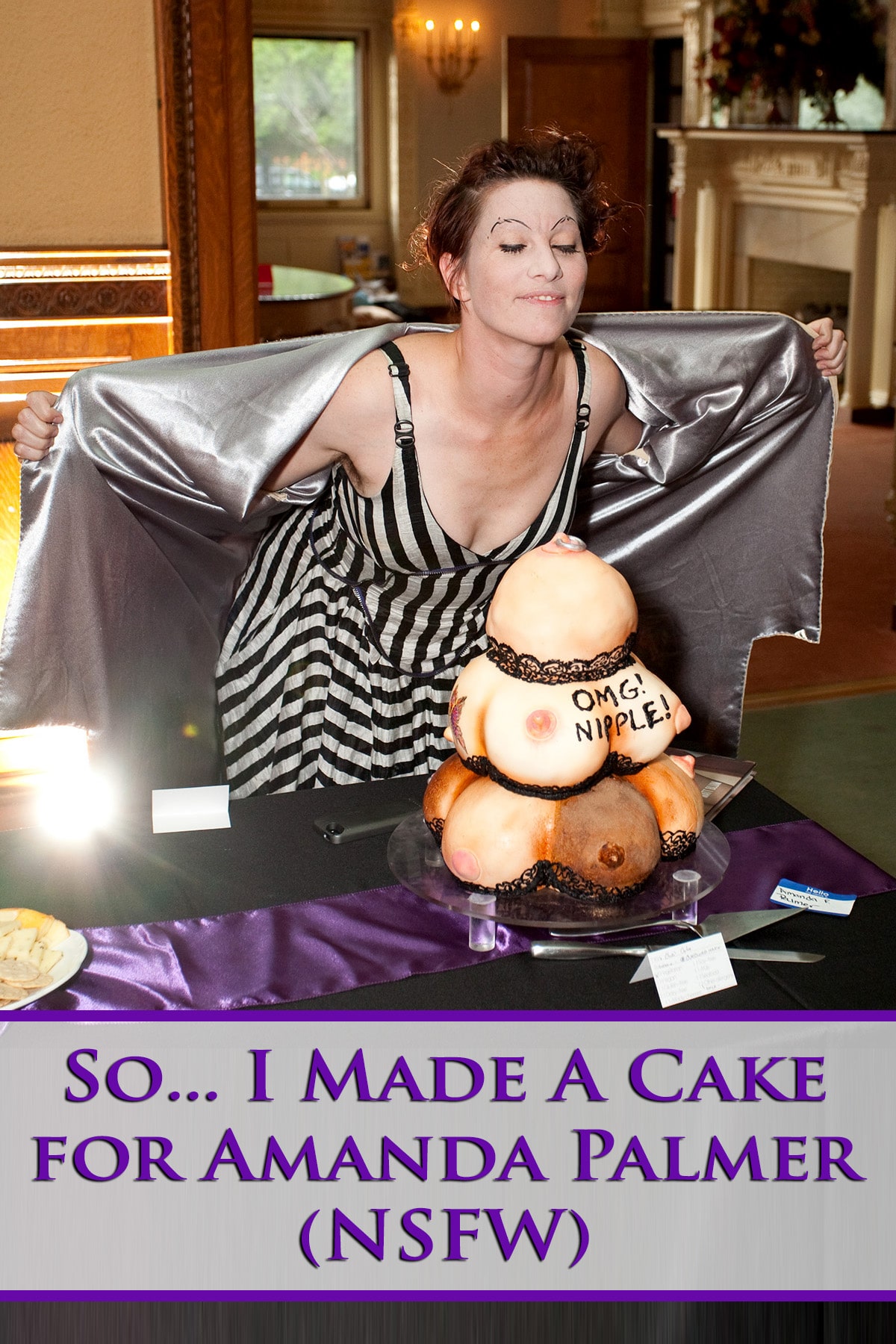 Amanda Palmer standing behind a cake that looks like a pile of breasts.