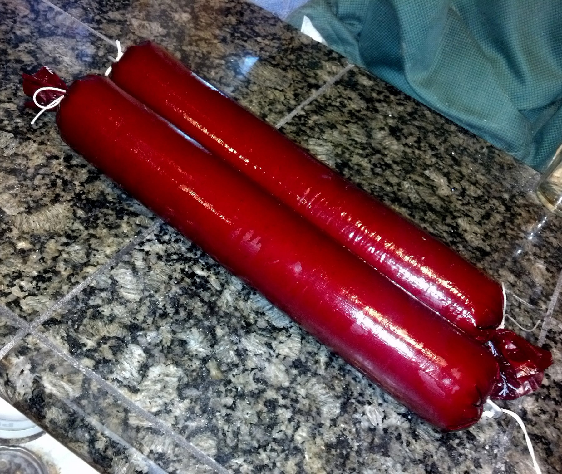 Two large red sausage casings filled with haggis and tied off.