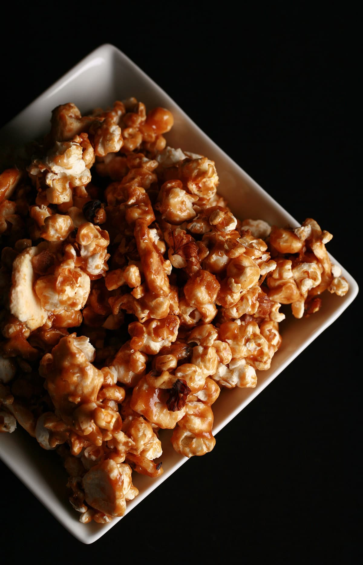 A close up view of a bowl of apple cinnamon caramel popcorn.