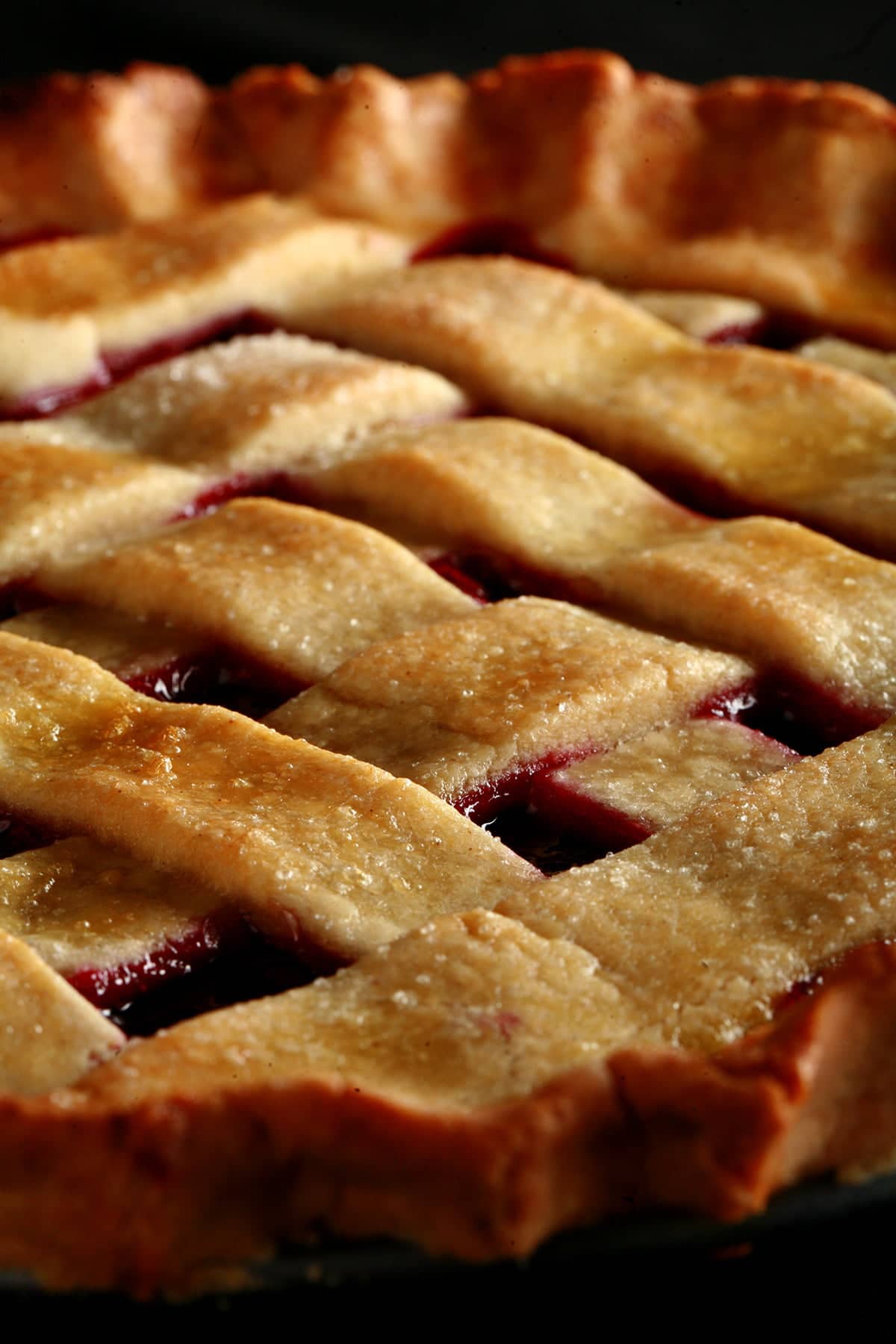 A close up view of a partridgeberry pie with a lattice crust.