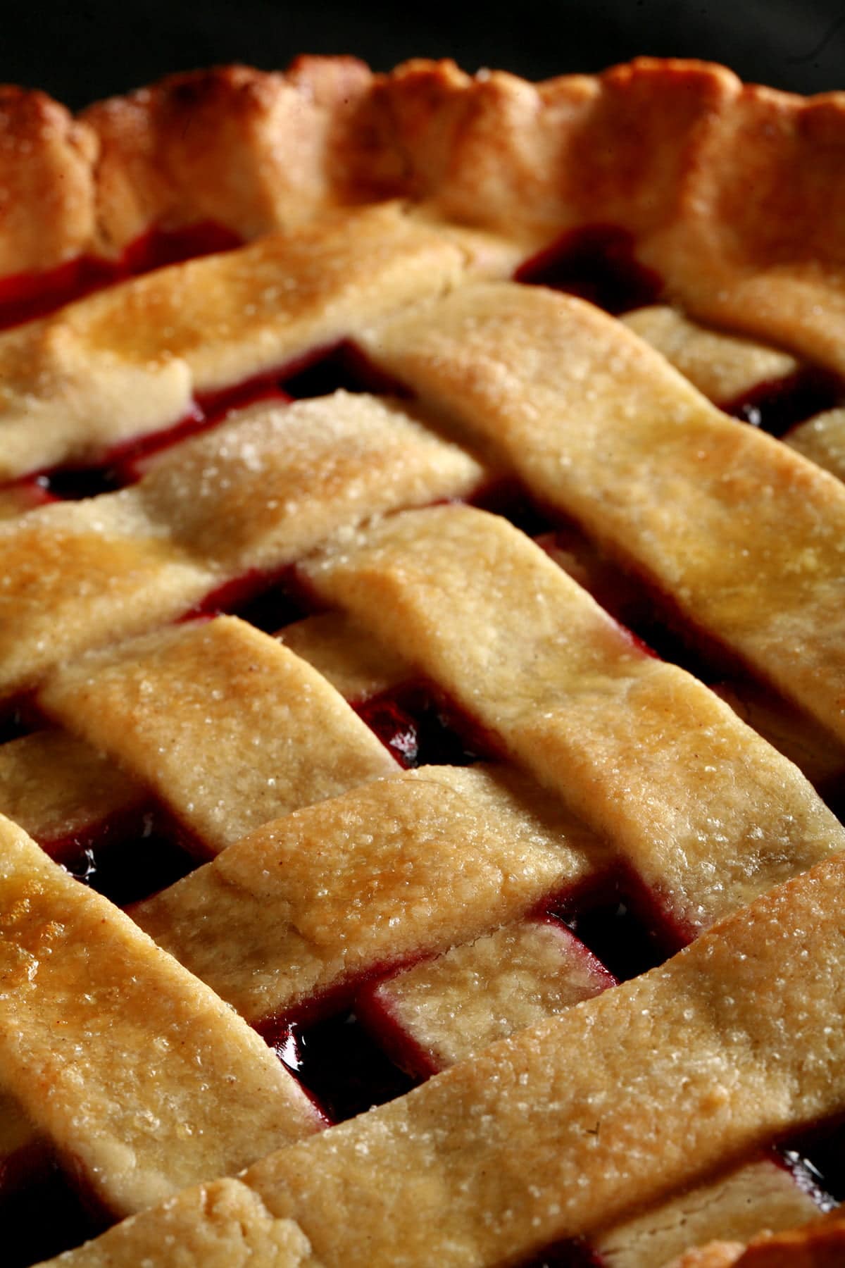 A close up view of a partridgeberry pie with a lattice crust.