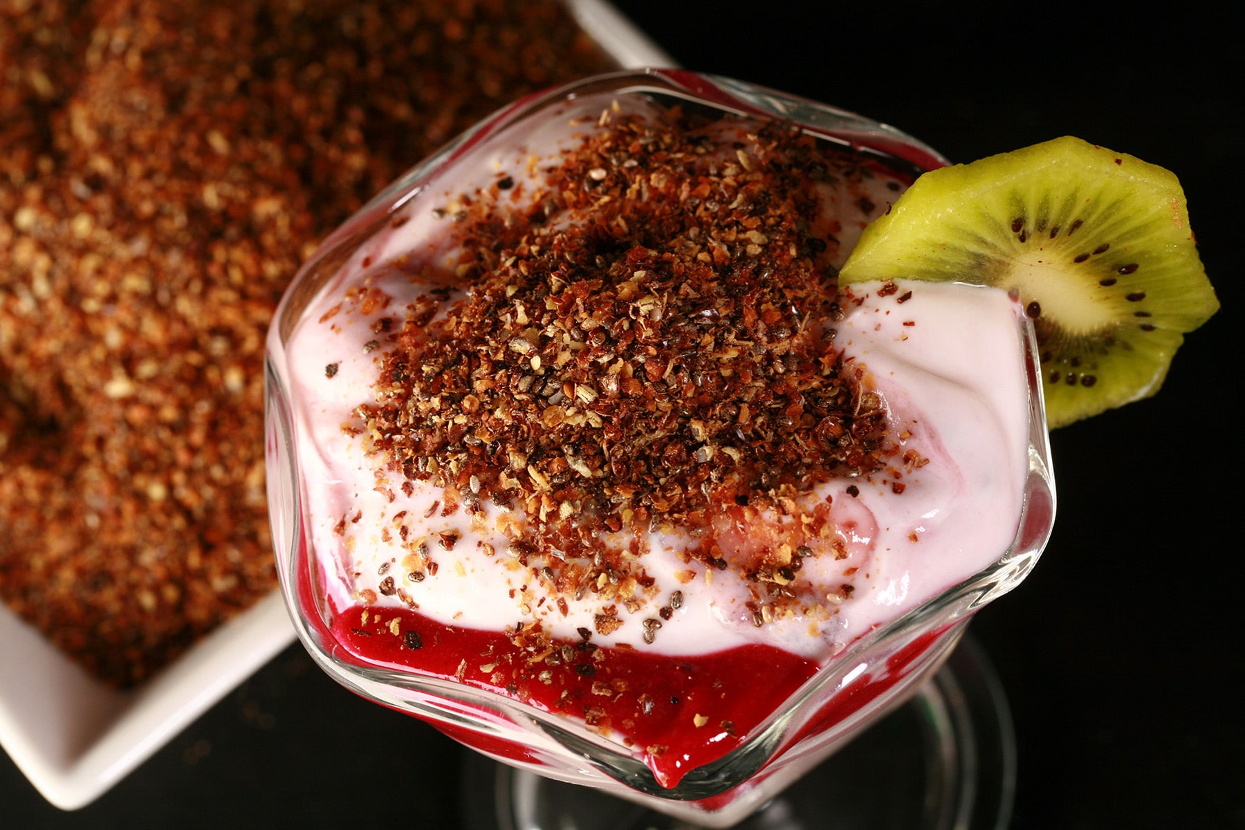 A parfait made with vanilla yogurt, blackcurrant curd, and our yogurt topping.