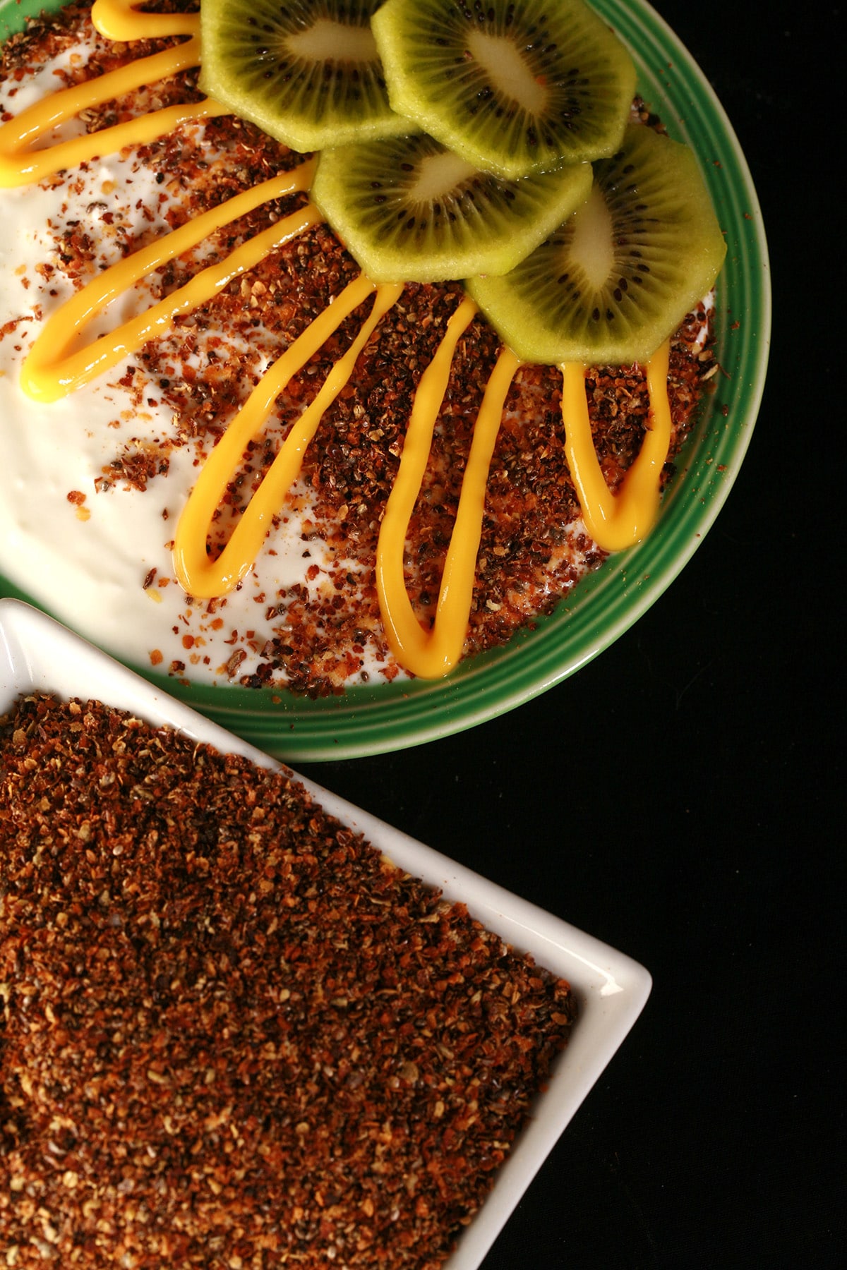 A bowl of vanilla yogurt, topped with our yogurt and ice cream topping, sliced kiwi, and a drizzle of mango curd.