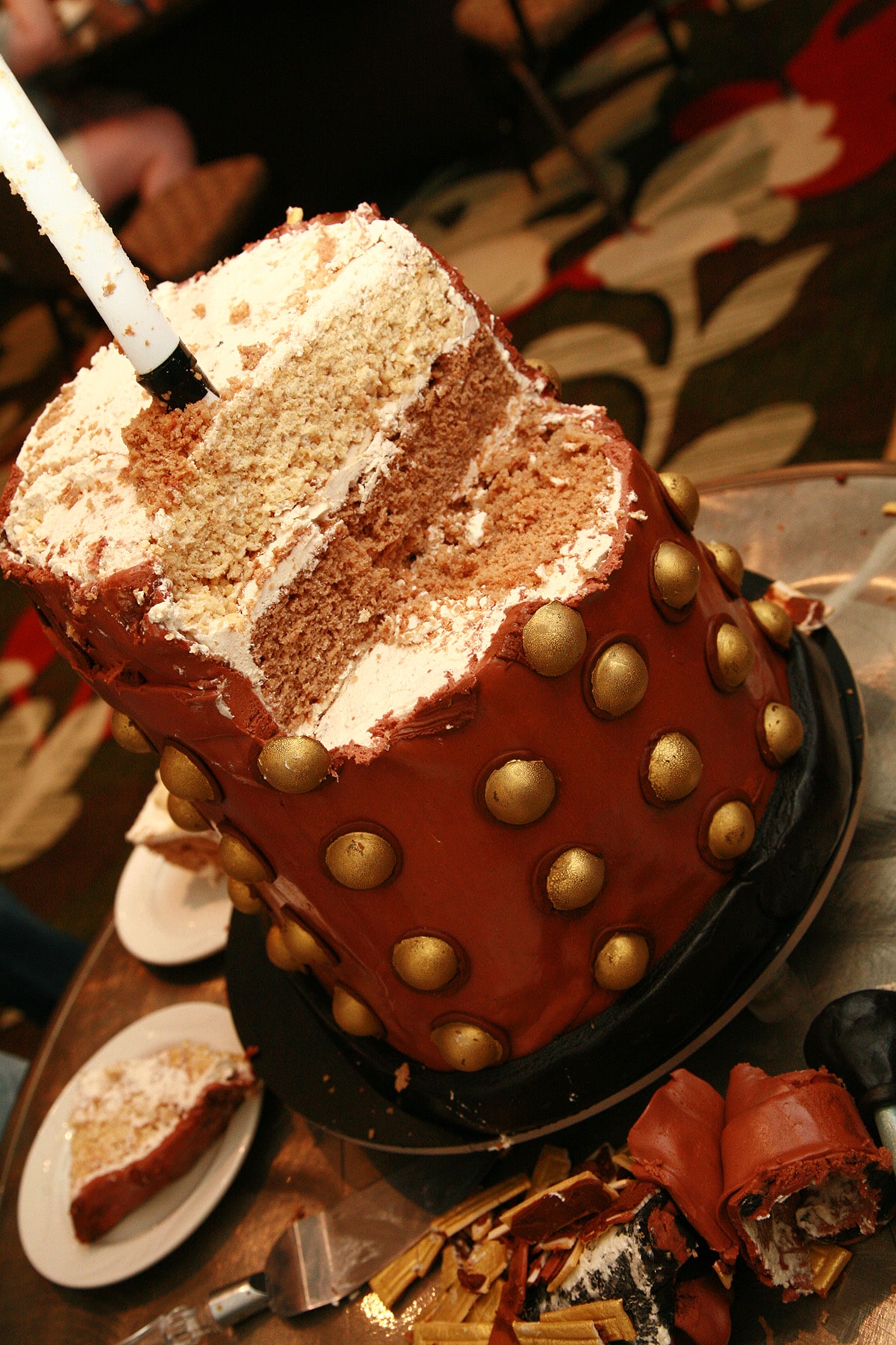 Half a Dalek cake, after much of it has been cut and served.