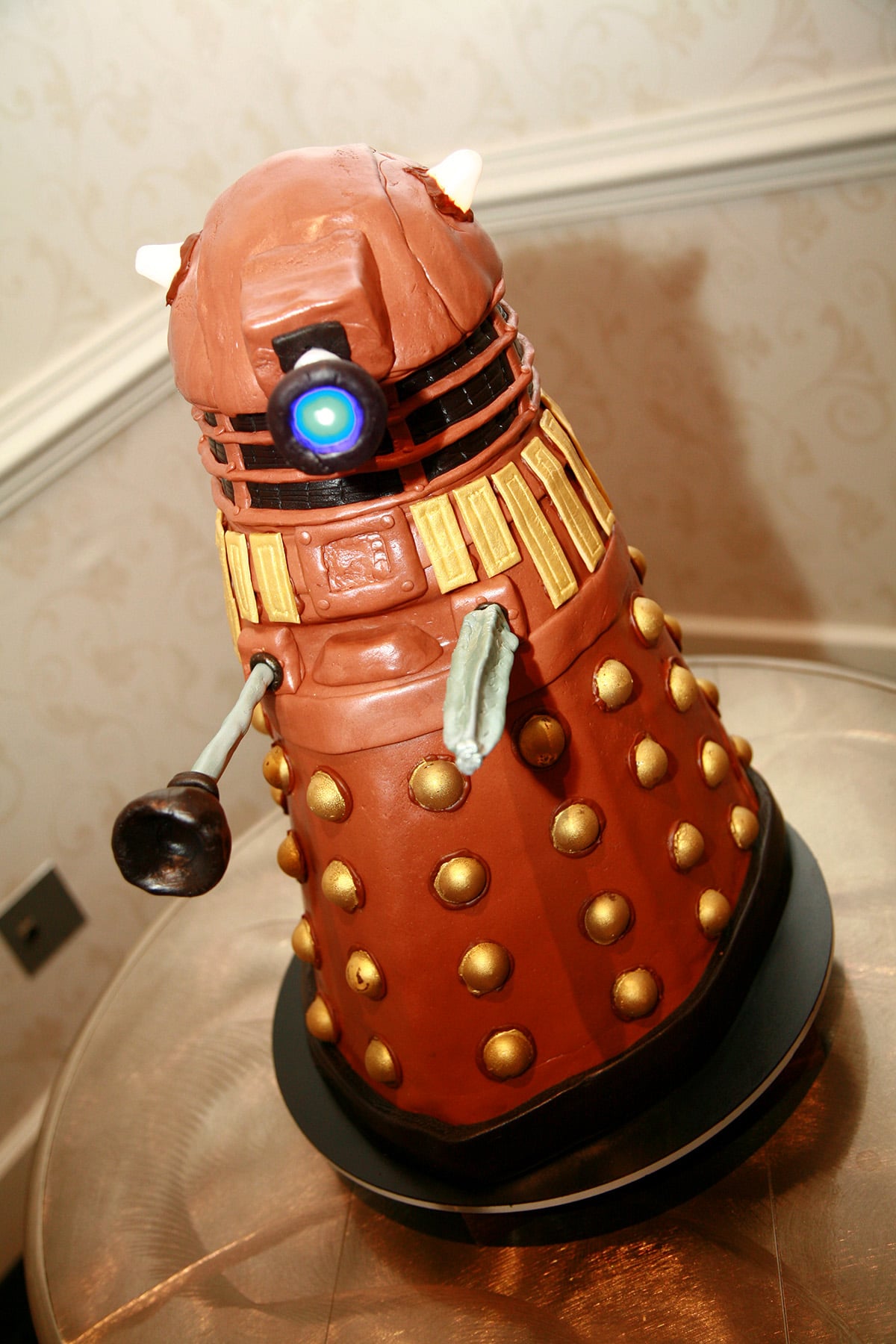 A tall dalek cake, with light up accents.