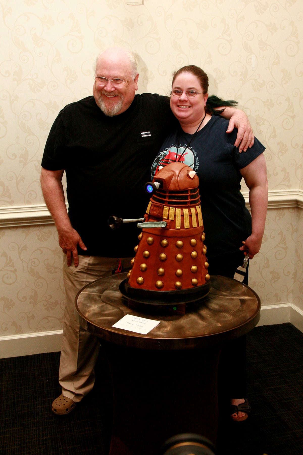 Colin Baker and Marie Porter pose behind the Dalek cake.