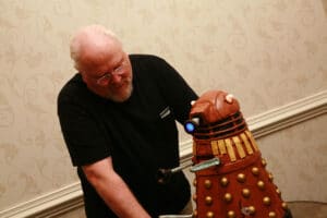 Colin Baker admiring the Dalek Cake