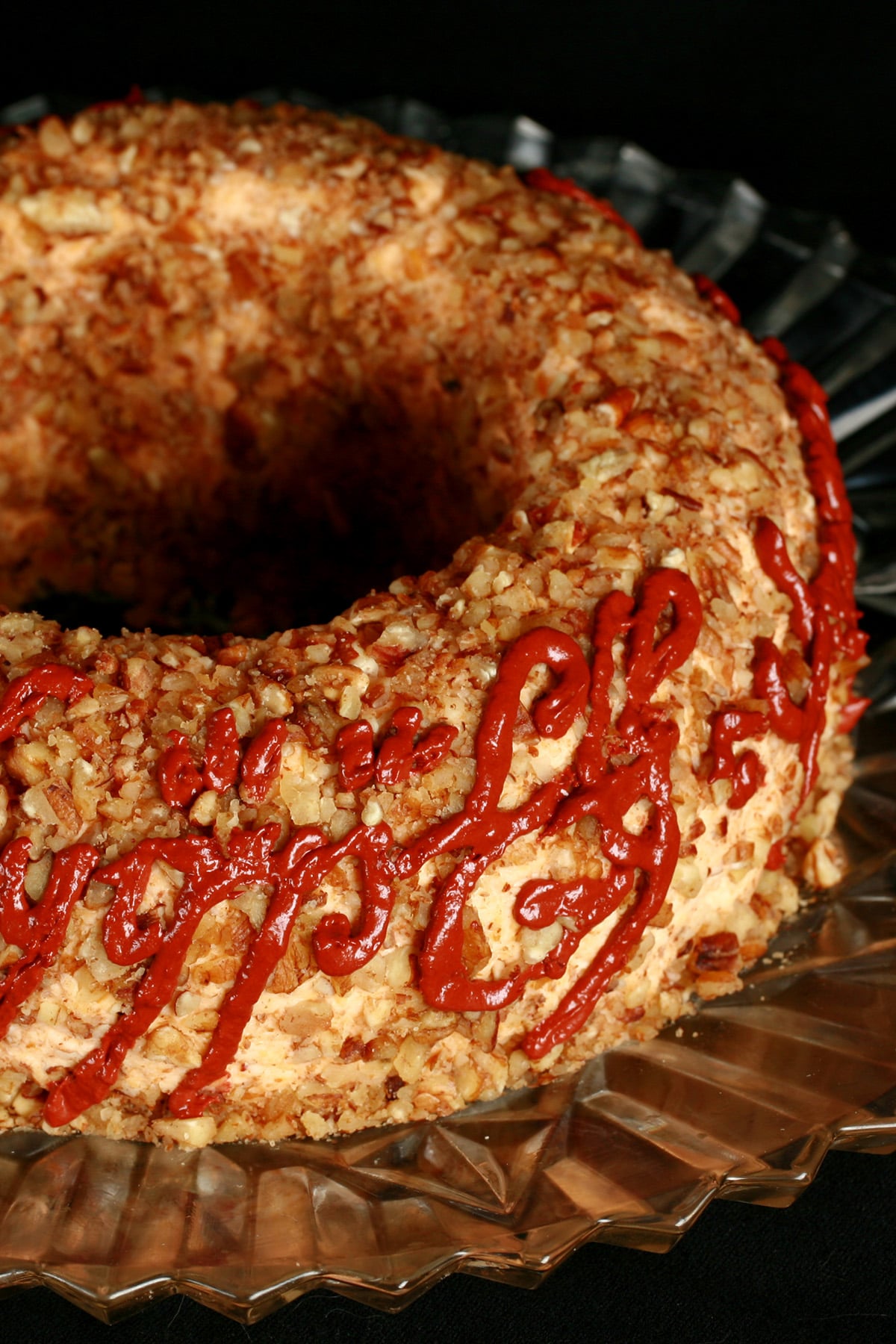 A large cheese ring, coated in nuts.  Tolkien's black speech One Ring inscription has been piped on the side, in deep red sun dried tomato paste.