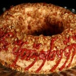 A large cheese ring, coated in nuts. Tolkien's black speech One Ring inscription has been piped on the side, in deep red sun dried tomato paste.