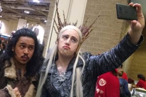 Cosplayers dressed as Thranduil and Radagast, taking a selfie.