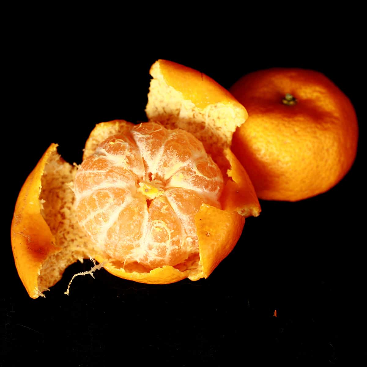 2 Kishu Mandarin oranges, one peeled.