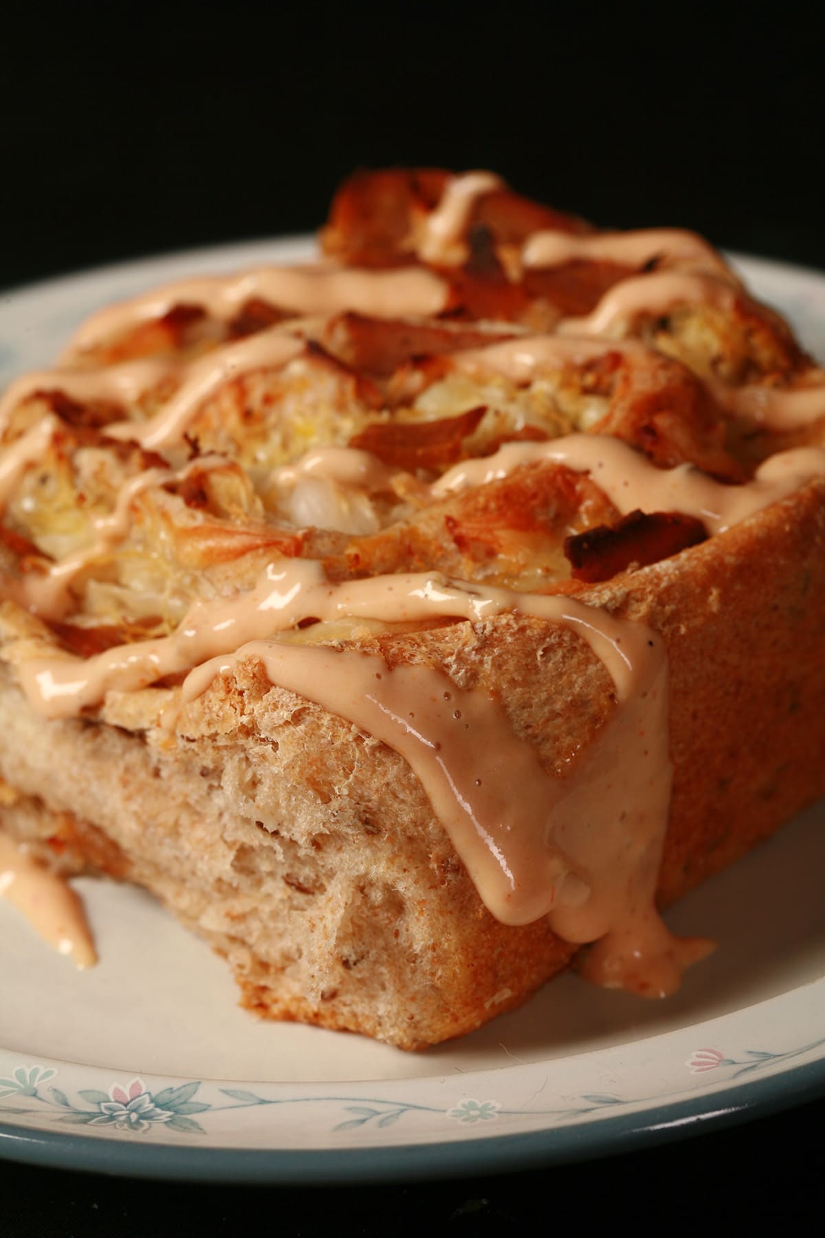 A large Reuben bun, drizzled with Thousand Island dressing.