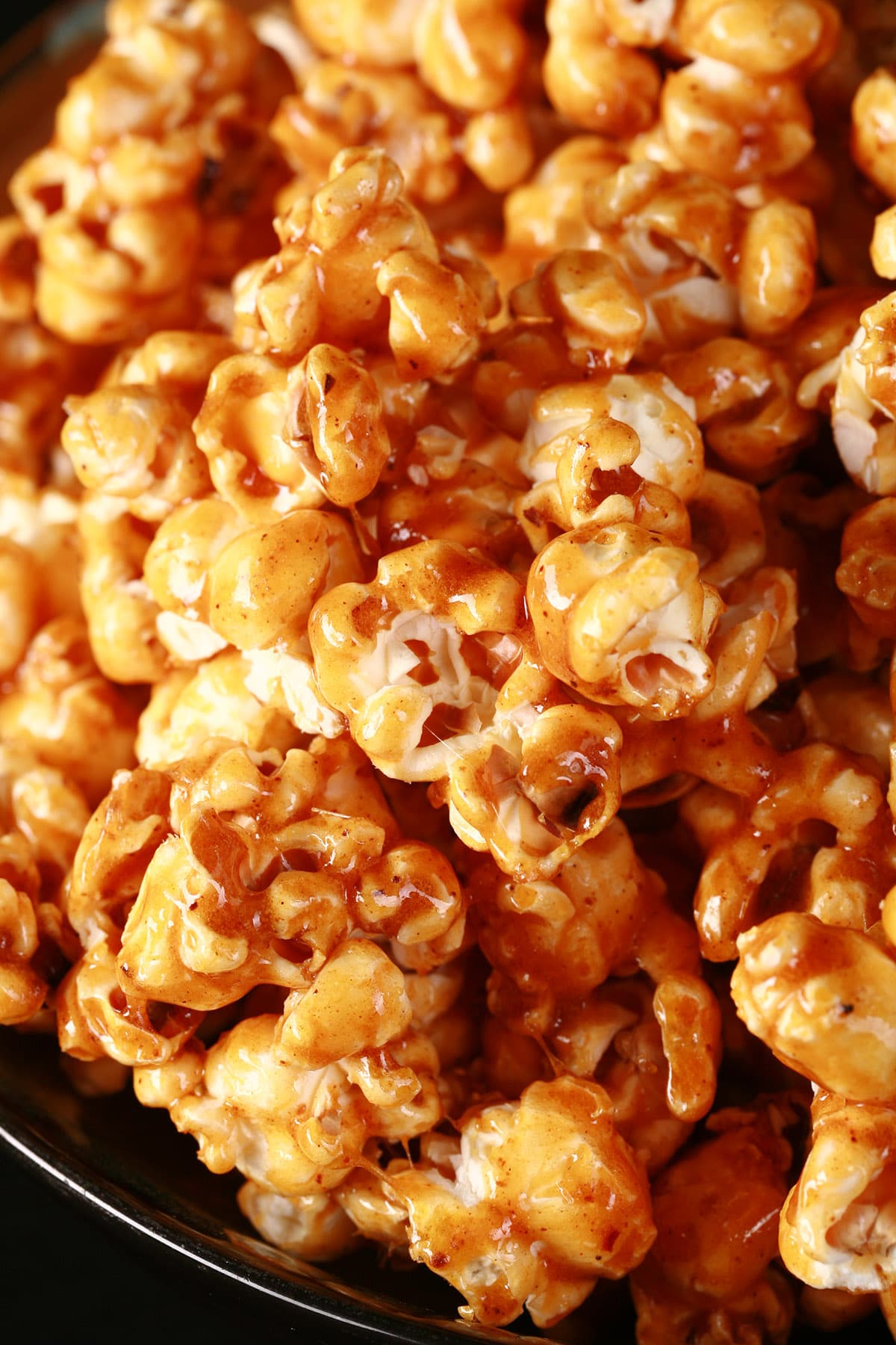 Close up view of a bowl of sweet heat salted caramel popcorn.